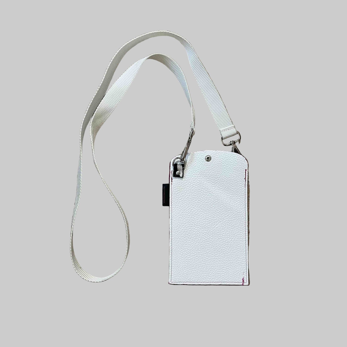 pink and white leather phone holder with cross body strap