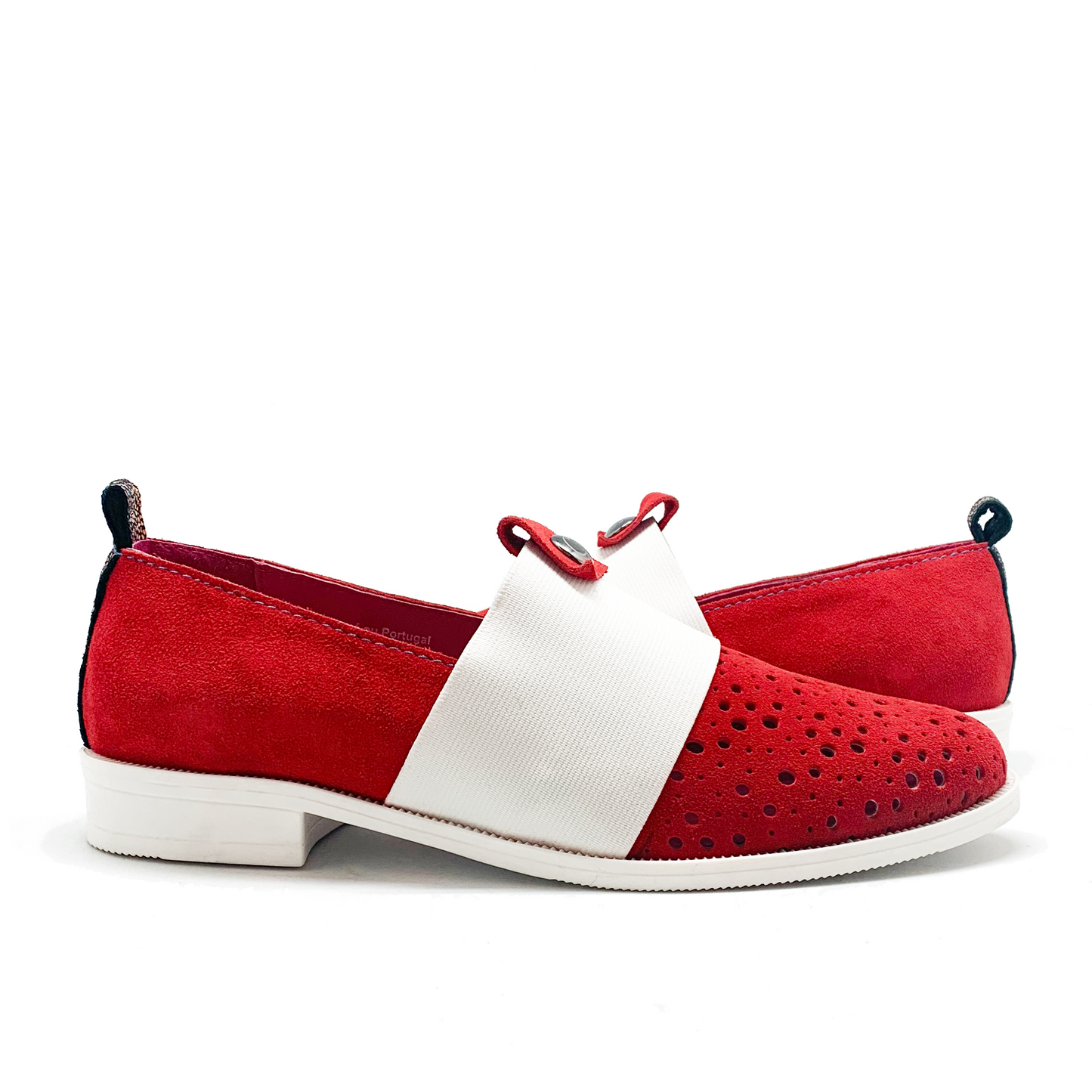 Red perforated suede slip on shoes with white elastic strap. 
