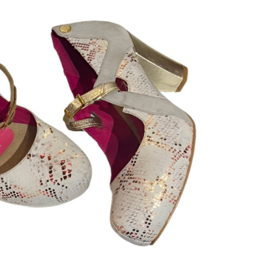 Pair of high-heeled shoes with pink interior on a white surface.