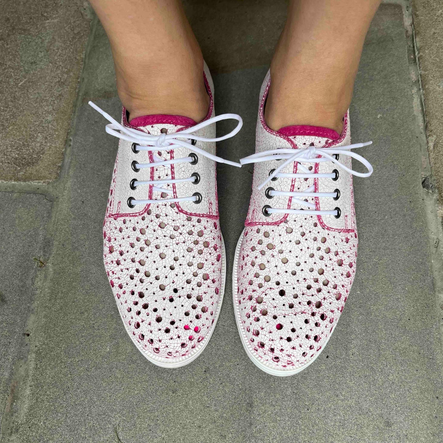 white and pink lace up shoes