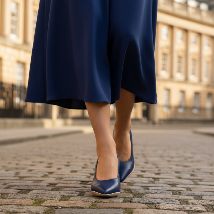 woman on a street front view of A royal blue leather low heel dress shoe with a pointed toe and low heel.