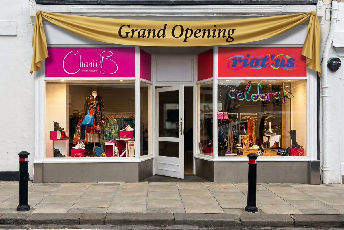 Shopfront with a draped gold fabric Grand Opening banner and reversed door hinges